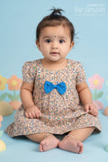 The Nesavu Baby Cotton Frocks Beige Floral Print Cotton Baby Frock for Girls with Blue Bow Accent Nesavu 10 (NB) / Beige BFJ562C-10 Beige Floral Cotton Baby Frock with Blue Bow