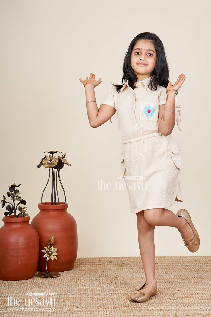 The Nesavu Girls Cotton Frock Beige girls cotton frock with collar and crochet flower patch Nesavu Nesavu beige girls cotton frock with collar and hand-crochet flower patch