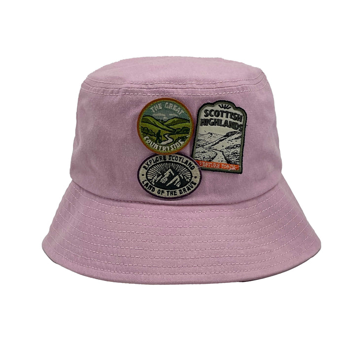 Pink bucket hat with patches on a white background