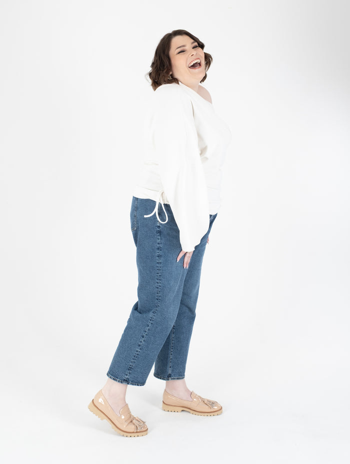 Tall woman wearing beige glossy loafers available in sizes 42 43 44 45 46 standard and wide fit