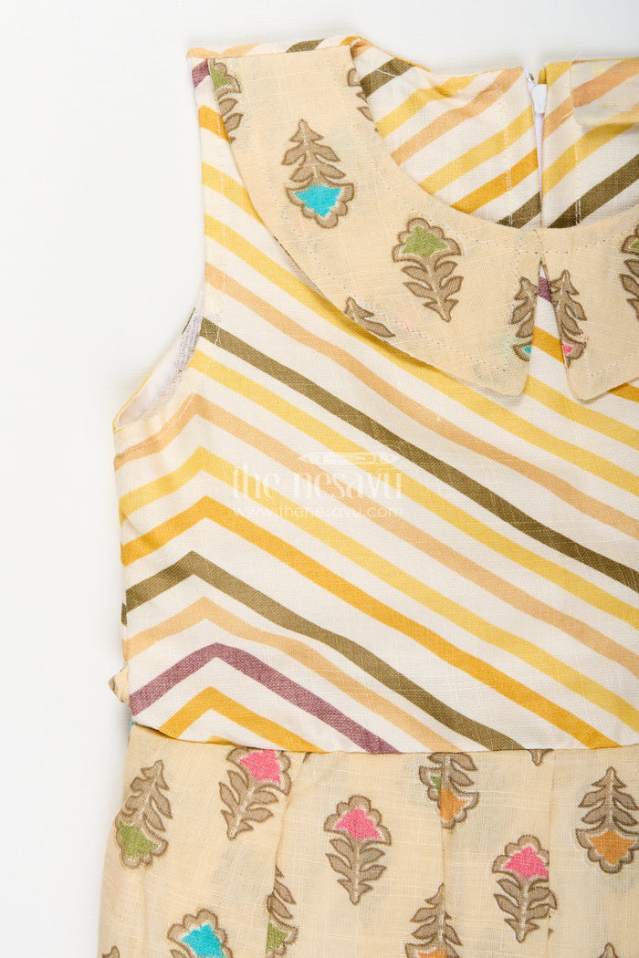 The Nesavu Girls Cotton Frock Girls cream frock with leaf block print and chevron stripes Nesavu Nesavu girls cream cotton frock with leaf print and chevron stripe bodice