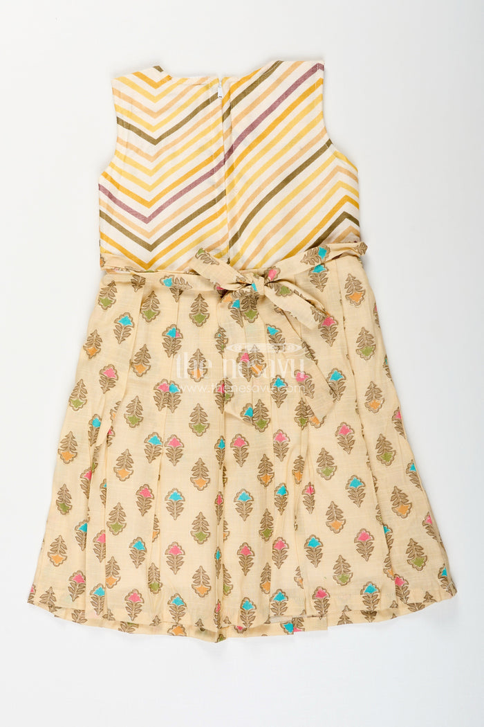 The Nesavu Girls Cotton Frock Girls cream frock with leaf block print and chevron stripes Nesavu Nesavu girls cream cotton frock with leaf print and chevron stripe bodice