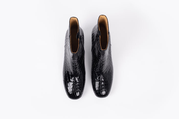 Izzy Boot by Otto + Ivy - an aerial profile of a black boot for tall women with large feet, featuring glossy black croc leather and a low chunky heel.
