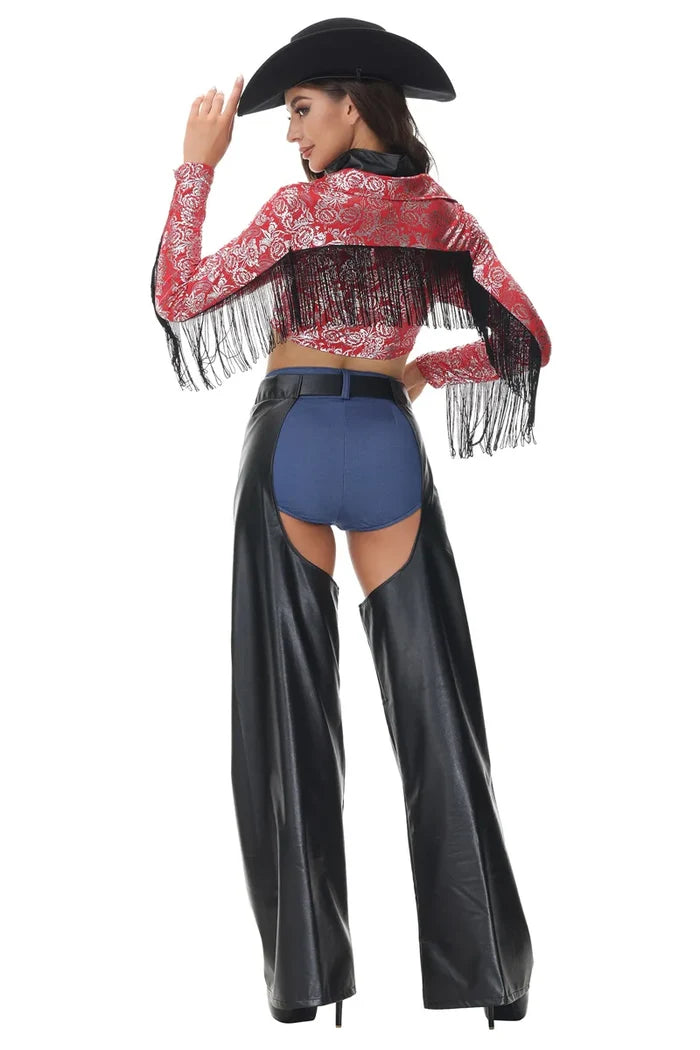 Person wearing a red fringed top, blue shorts, and black leather pants with a black cowboy hat on a white background.