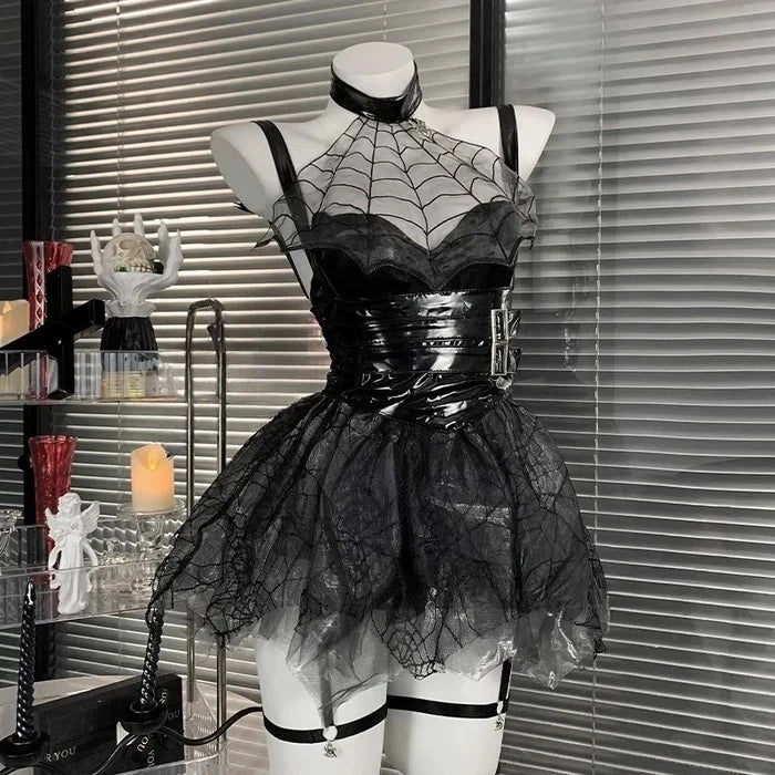 Black lace and vinyl dress on a mannequin against a window with blinds.
