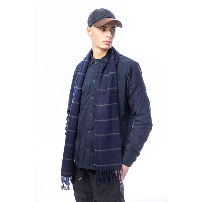 Male model wearing a blue box check baseball cap standing in front of a white background
